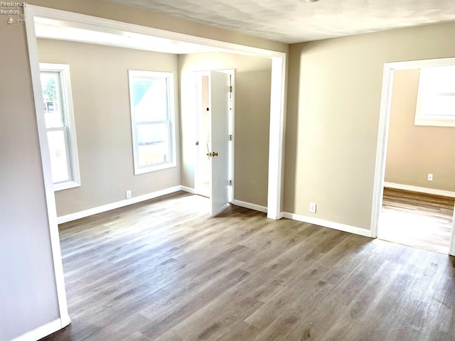 empty room featuring baseboards and wood finished floors