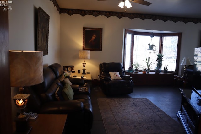 living area featuring wood finished floors and ceiling fan