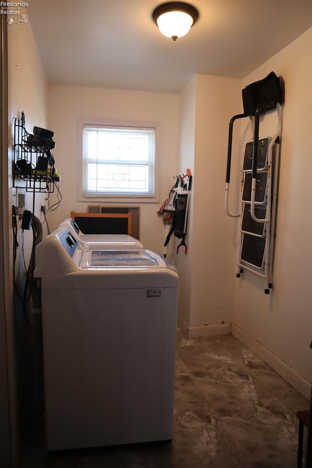 laundry area with washer and dryer, laundry area, and baseboards