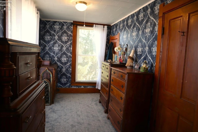 bedroom with wallpapered walls and carpet flooring