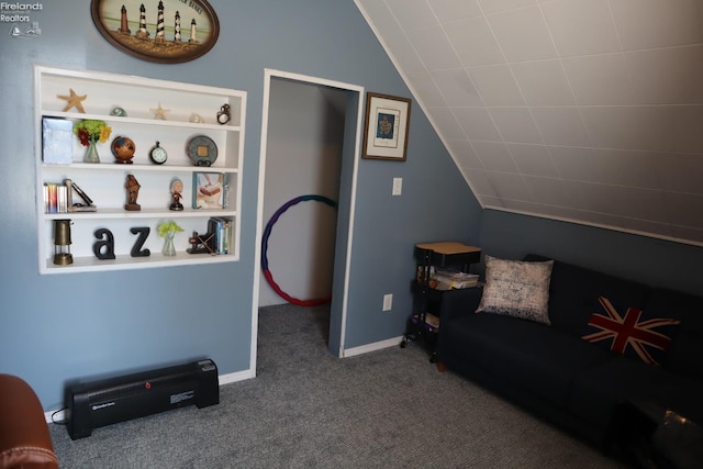 sitting room featuring baseboards, built in shelves, carpet flooring, and vaulted ceiling