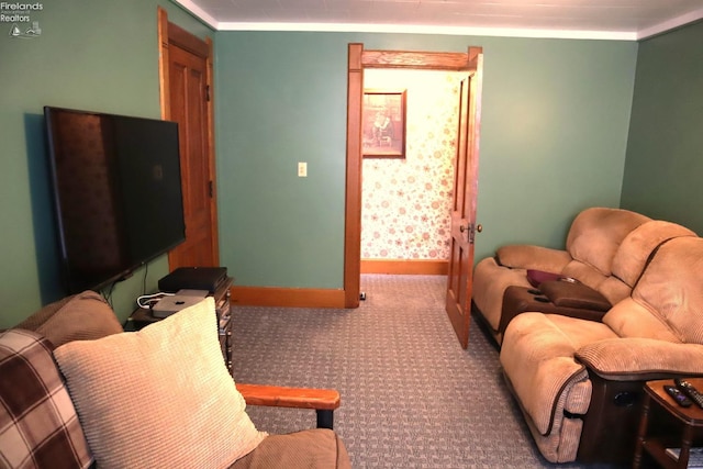 carpeted living area with baseboards and crown molding