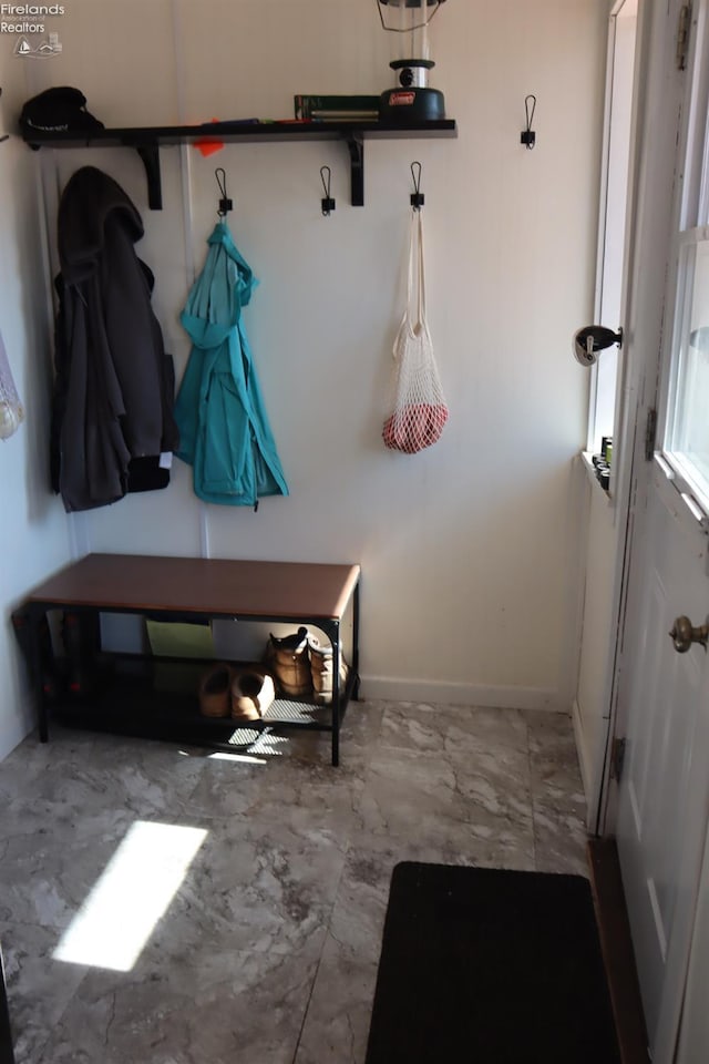 mudroom featuring baseboards and marble finish floor