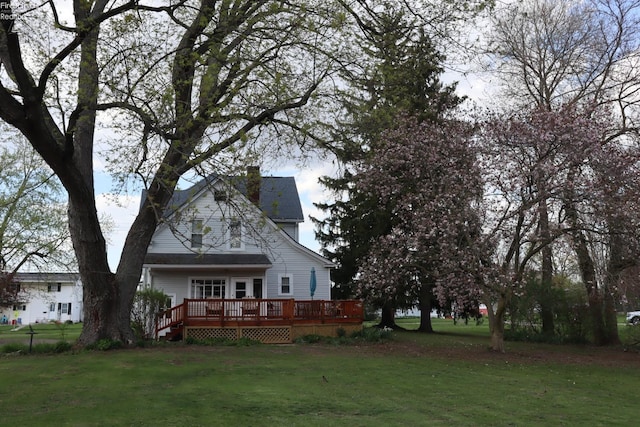 115 W Main St, New London, OH 44851 - back of property with a deck, a chimney, and a yard