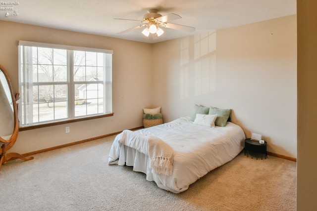 bedroom with baseboards, carpet floors, and a ceiling fan