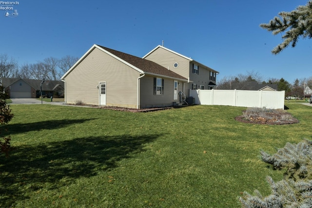 view of property exterior with a yard and fence