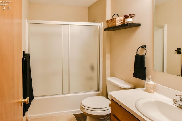 bathroom featuring toilet, vanity, and shower / bath combination with glass door