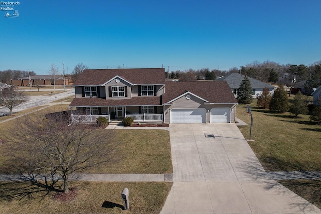 view of front of property featuring a garage, covered porch, concrete driveway, and a front yard