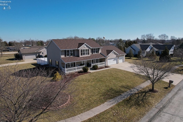 view of front of property featuring a front lawn, an attached garage, covered porch, and driveway