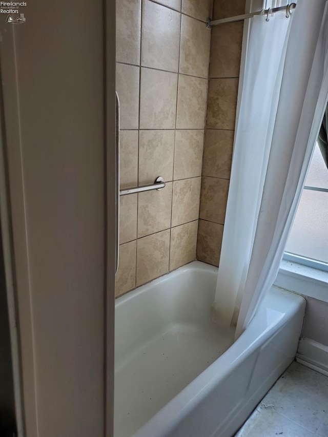 full bath featuring shower / tub combo with curtain