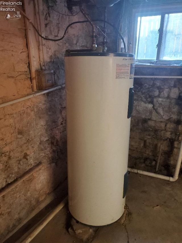 utility room featuring water heater