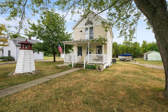 view of front of home with central air condition unit, a porch, and a front lawn