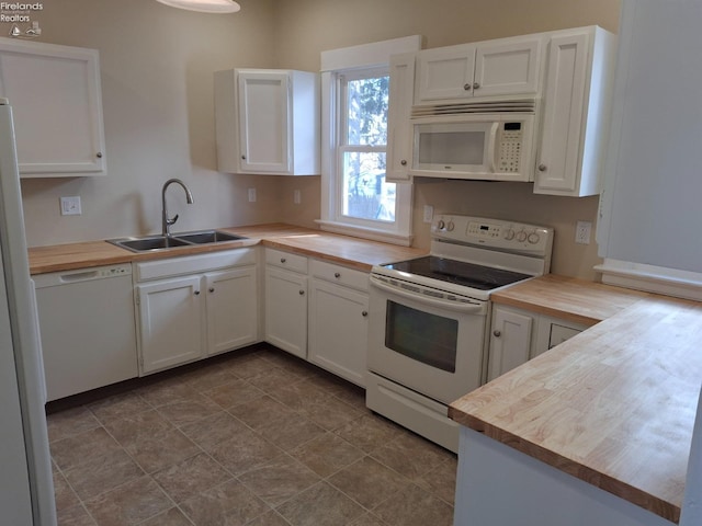 kitchen featuring wooden counters, white cabinets, white appliances, and a sink