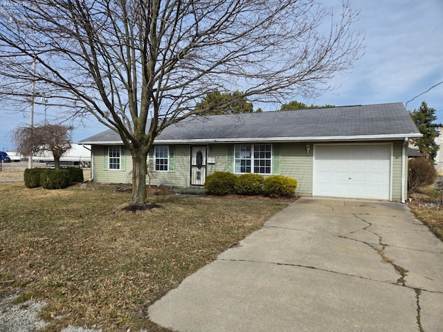 single story home featuring driveway, an attached garage, and a front yard