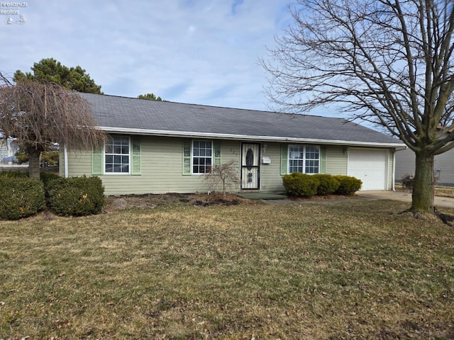 single story home with a front lawn, an attached garage, and driveway