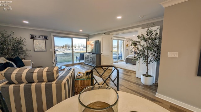 living area with recessed lighting, ornamental molding, baseboards, and wood finished floors