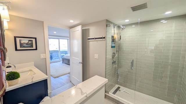 bathroom with recessed lighting, visible vents, vanity, and a shower stall