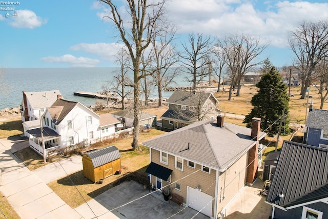 bird's eye view featuring a water view and a residential view