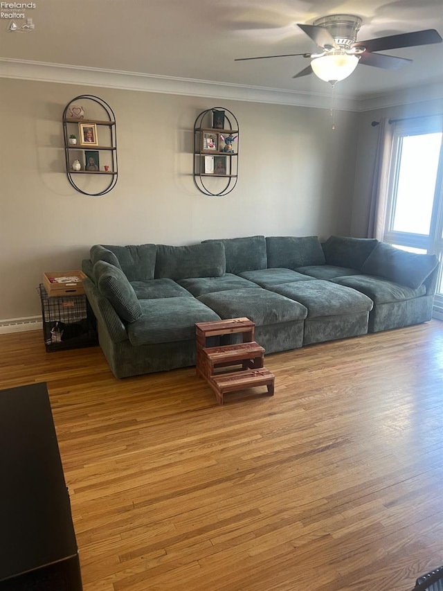 living area featuring a ceiling fan, wood finished floors, and crown molding