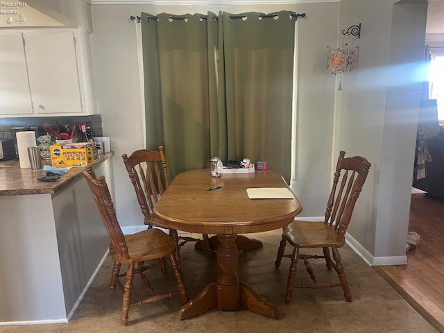 dining area featuring baseboards