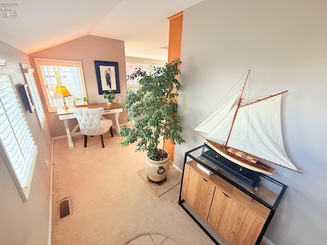 sitting room featuring visible vents, baseboards, carpet, and vaulted ceiling