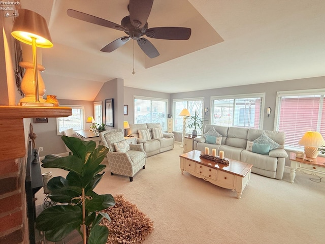 carpeted living area featuring vaulted ceiling, a healthy amount of sunlight, and ceiling fan