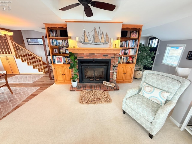 living area with stairway, carpet flooring, a fireplace, baseboards, and vaulted ceiling