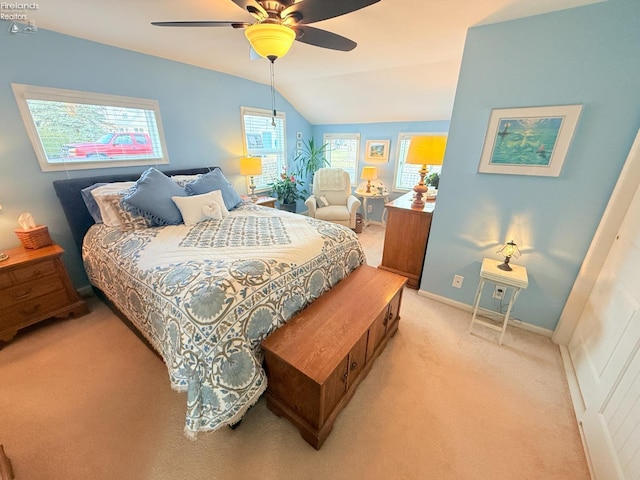 bedroom with baseboards, light carpet, ceiling fan, and vaulted ceiling