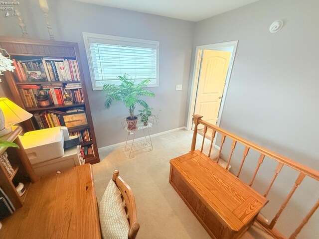 carpeted home office with baseboards