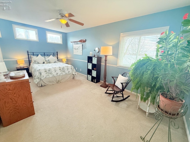 bedroom featuring baseboards, multiple windows, carpet, and ceiling fan