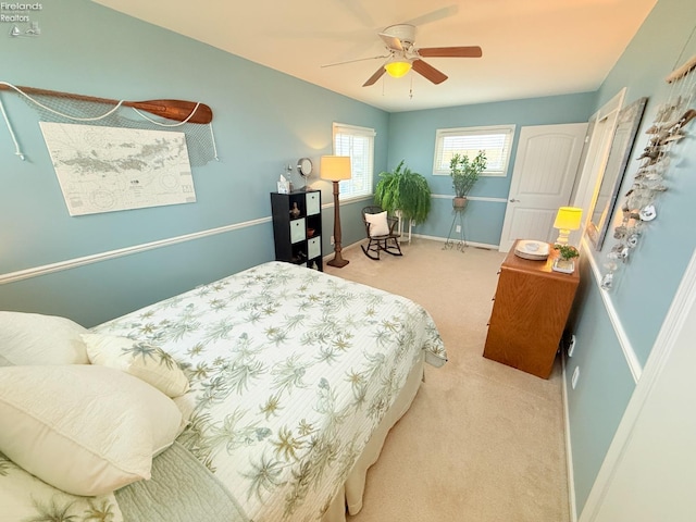 carpeted bedroom featuring a ceiling fan and baseboards