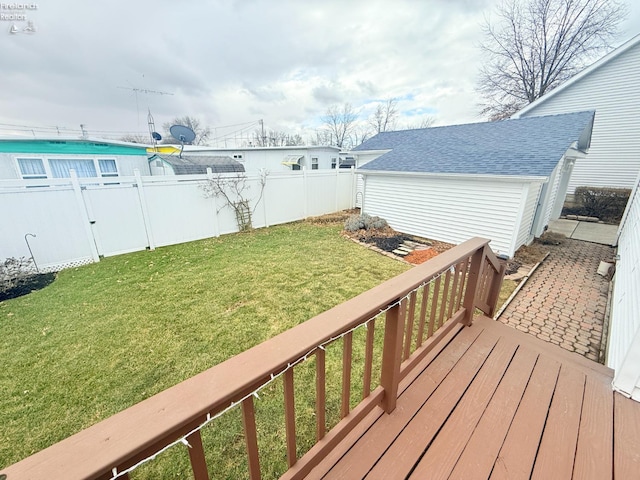 wooden terrace featuring a yard, an outdoor structure, and fence