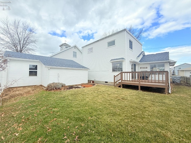 rear view of property with a yard and a wooden deck