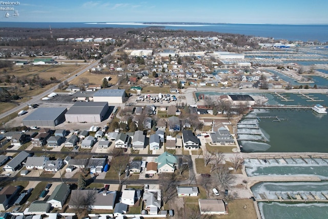 drone / aerial view featuring a residential view and a water view