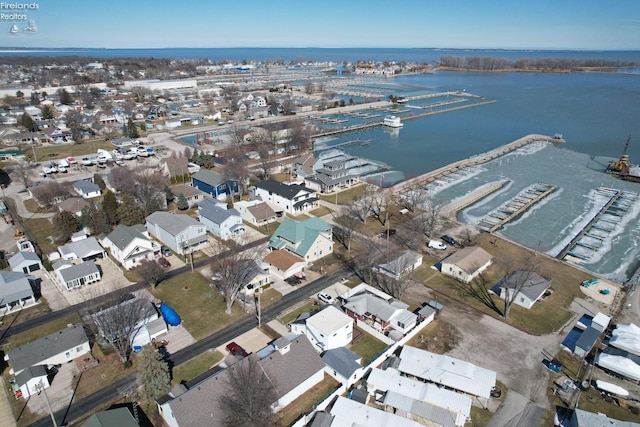 birds eye view of property with a water view and a residential view