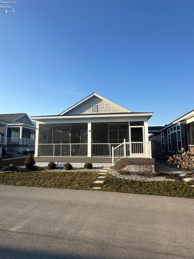 view of front of property featuring a sunroom