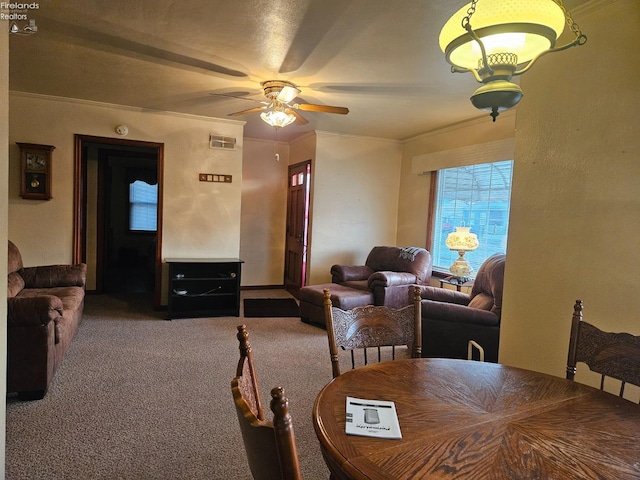 dining area featuring visible vents, carpet flooring, ceiling fan, and ornamental molding