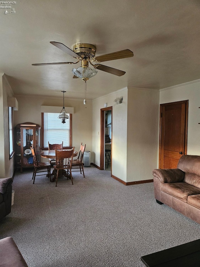 carpeted dining area with visible vents, baseboards, and ceiling fan