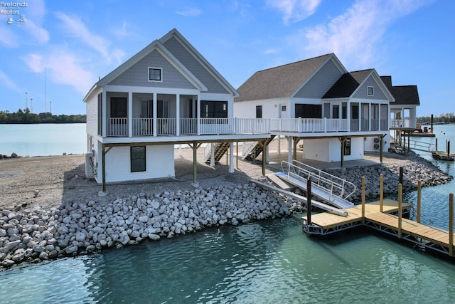 view of dock with a deck with water view and stairs