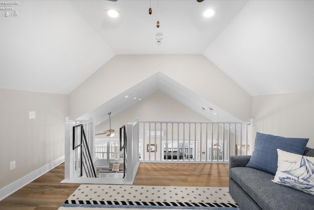 interior space with wood finished floors, a ceiling fan, and lofted ceiling