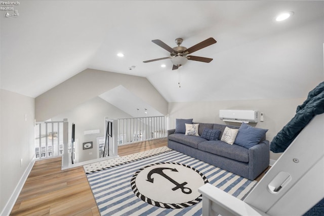 living room with baseboards, a wall unit AC, vaulted ceiling, recessed lighting, and light wood-style flooring