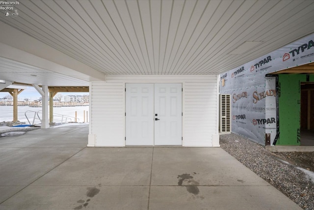 view of exterior entry with a patio