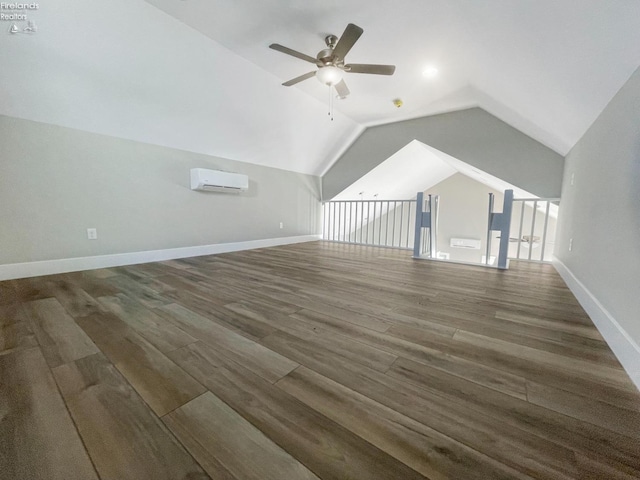 bonus room featuring baseboards, ceiling fan, a wall mounted air conditioner, lofted ceiling, and wood finished floors