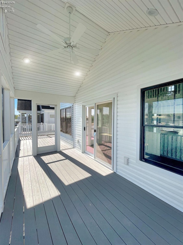 wooden deck with a ceiling fan