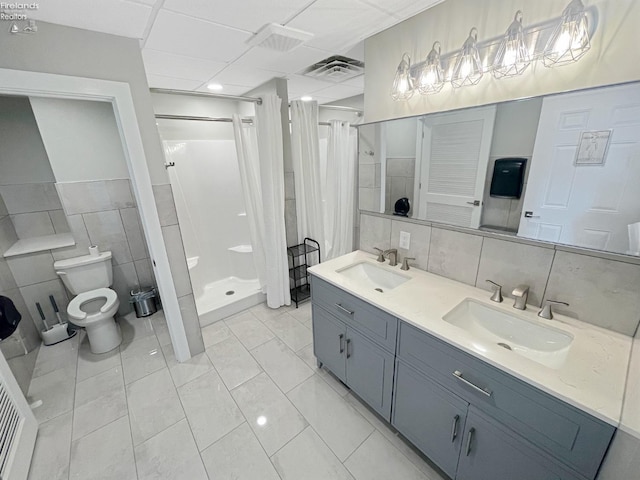 bathroom featuring a sink, visible vents, toilet, and a shower stall