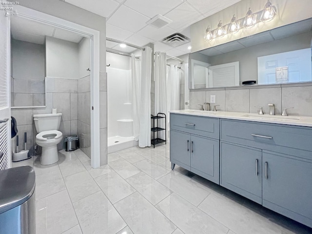 full bath with visible vents, toilet, a stall shower, a sink, and tile walls