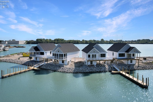 dock area featuring stairway and a water view