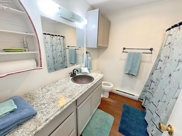 full bath featuring toilet, a shower with shower curtain, baseboard heating, wood finished floors, and vanity