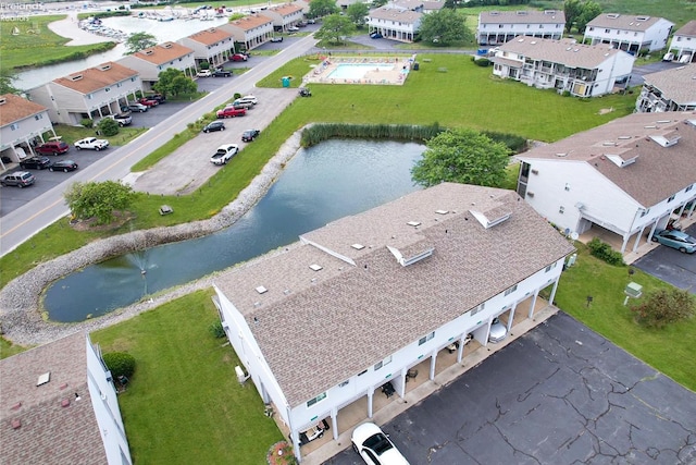 bird's eye view with a water view and a residential view