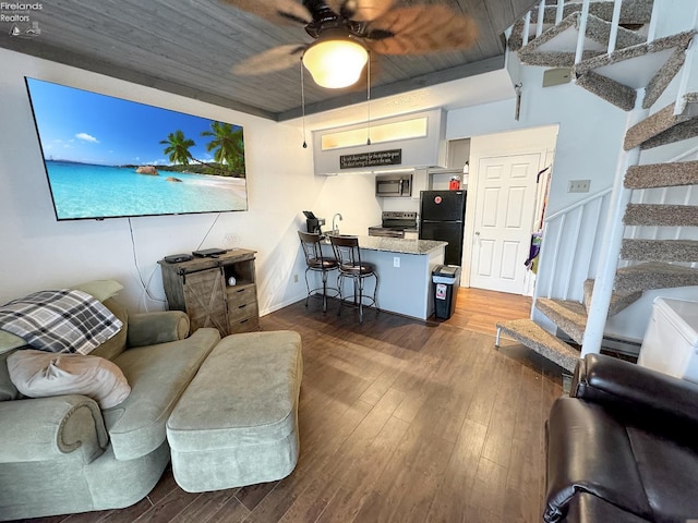 living area featuring a ceiling fan, wood ceiling, dark wood-style floors, and stairs